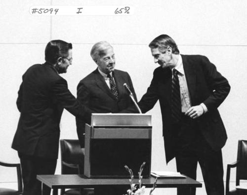 William Friday (left) shaking hands with Suderburg (right), with Dr. James Semans in middle.