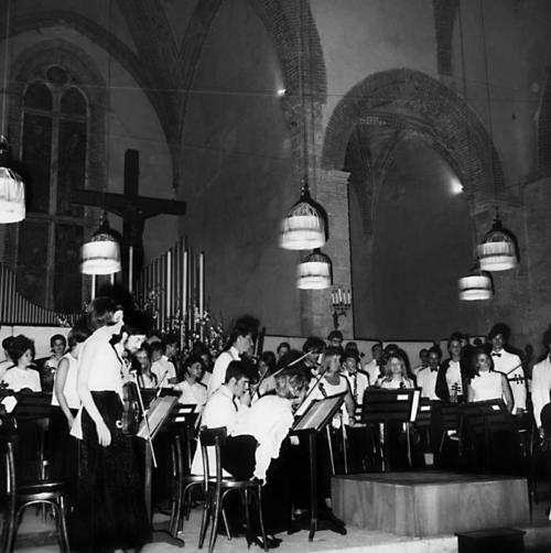 Orchestra standing (receiving applause) after giving performance at Basilica di San Lucchese, Stamped on back: Fotografia/Cinematografia...Lucii