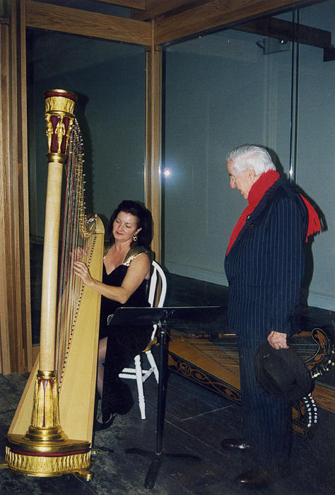 Dr. James Semans (right) listens as a harpist performafter performance.