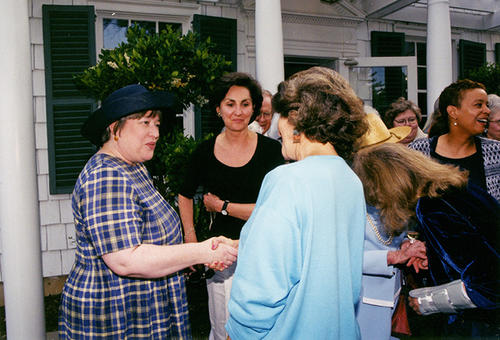 Bates (far left) greets a guest (back to camera).