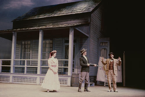 Left to right: Kirstie Marianne Tice as Ado Annie Carnes, Tom Juarez as Andrew Carnes and Matthew Buzzell as Ali Hakim in a scene in which Andrew Carnes finds his daughter, Ado Annie, with Ali Hakim and tries to get Hakim to marry Ado Annie at gunpoint.