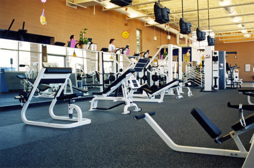 Exercise machines and students working out